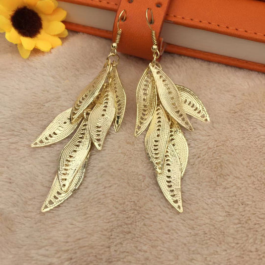 Three-dimensional curved surface hollow wicker tassel female earrings Yunnan minority fashion metal earrings
