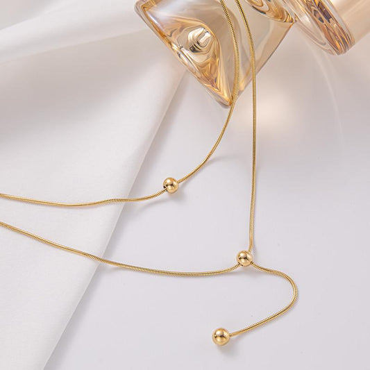 Double-layer stacked tassel necklace female small golden bean double-layer collarbone chain simple titanium steel transfer bead necklace