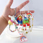 Simple monster rainbow non-slip bag chain cute cinnamon dog soft pottery mobile phone case anti-lost pendant pearl chain