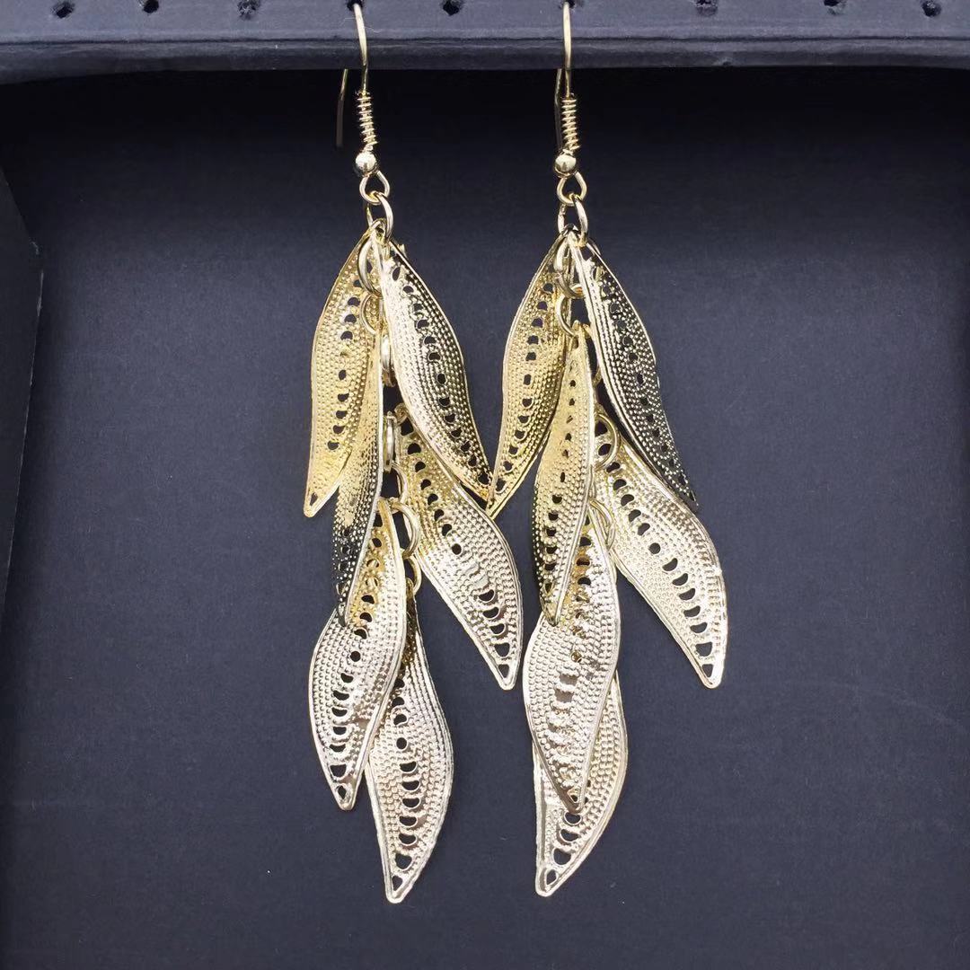 Three-dimensional curved surface hollow wicker tassel female earrings Yunnan minority fashion metal earrings