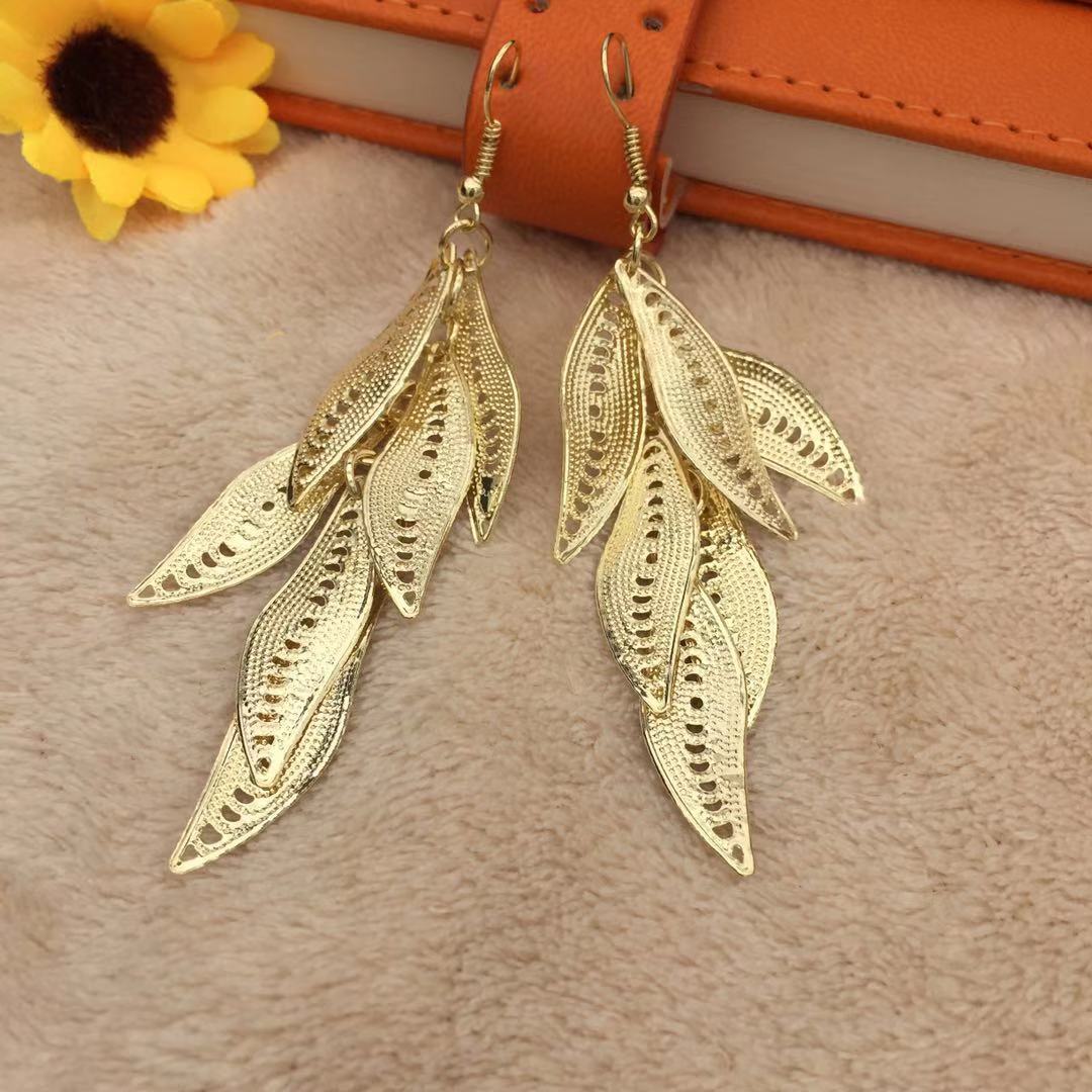 Three-dimensional curved surface hollow wicker tassel female earrings Yunnan minority fashion metal earrings