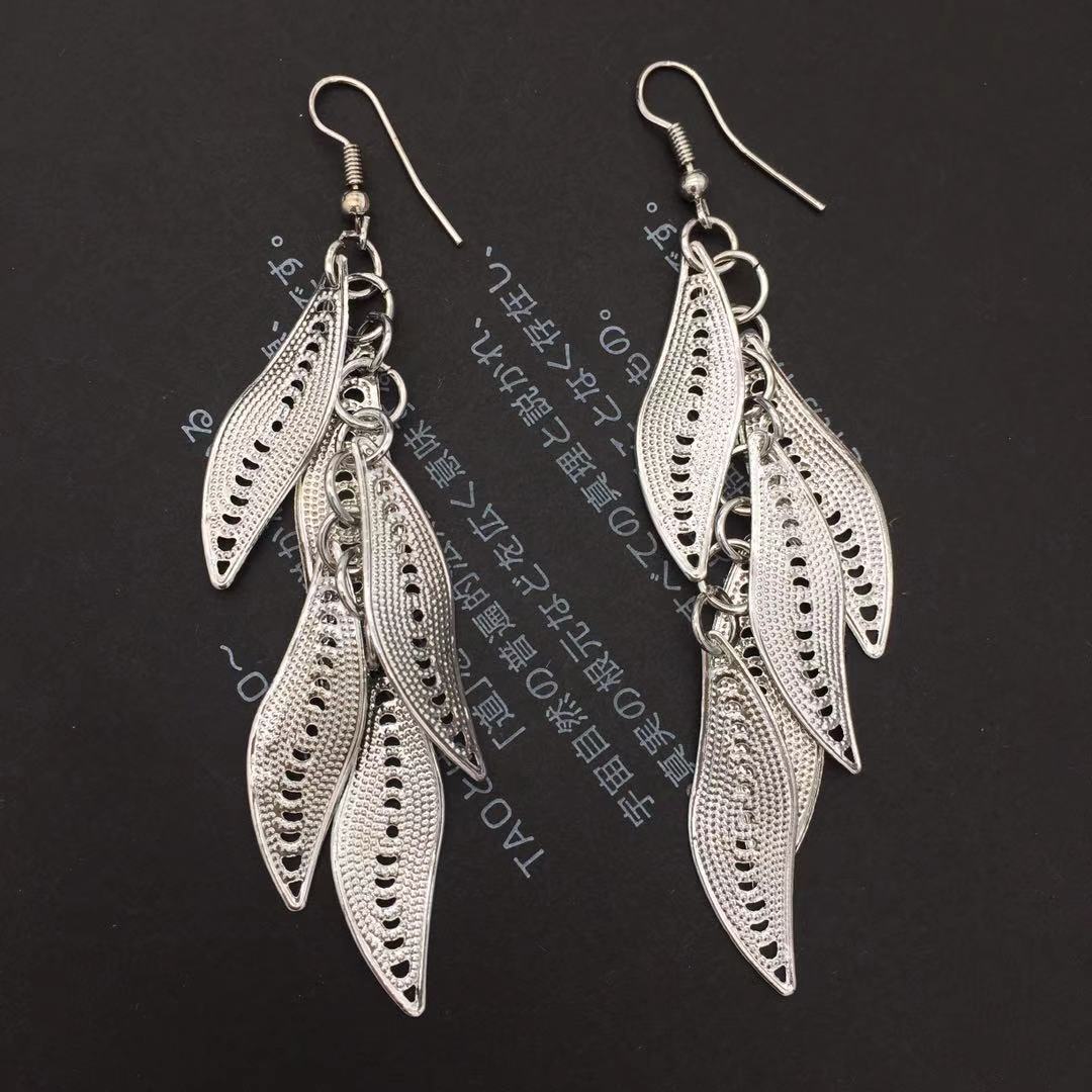 Three-dimensional curved surface hollow wicker tassel female earrings Yunnan minority fashion metal earrings