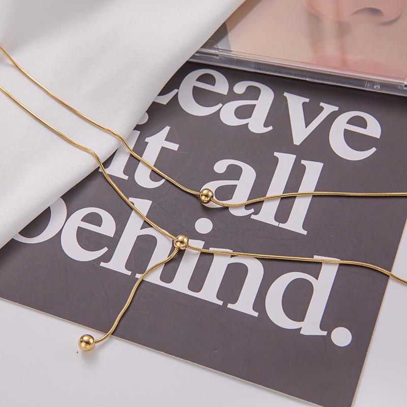 Double-layer stacked tassel necklace female small golden bean double-layer collarbone chain simple titanium steel transfer bead necklace