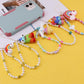 Simple monster rainbow non-slip bag chain cute cinnamon dog soft pottery mobile phone case anti-lost pendant pearl chain