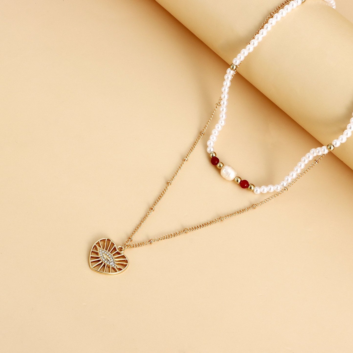 Jewelry fashion double-layer beaded imitation pearl necklace female hollow heart devil's eye pendant necklace