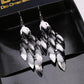 Atmospheric ethnic long string leaf-shaped brushed metal earrings