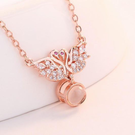 I love you necklace in one hundred languages with two little swan micro-set pendants