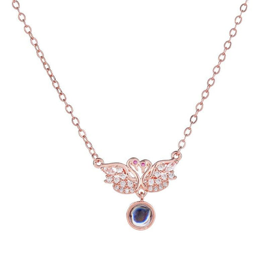 I love you necklace in one hundred languages with two little swan micro-set pendants