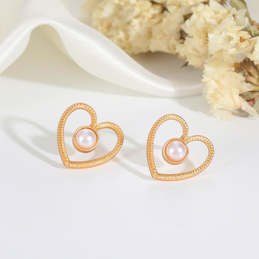 Ins inlaid pearl love earrings female fashion temperament niche design hollow love earrings simple earrings