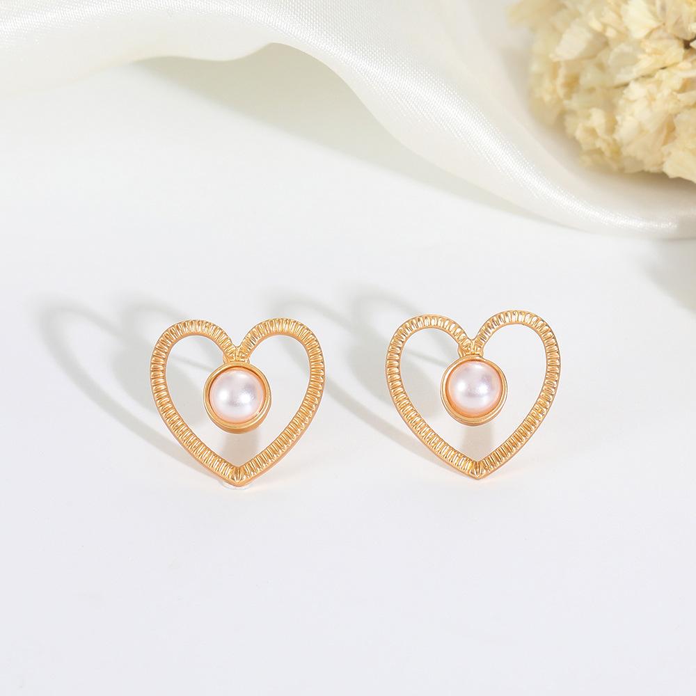 Ins inlaid pearl love earrings female fashion temperament niche design hollow love earrings simple earrings